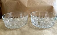 Both clear cut glass bowls side by side showing exterior pattern