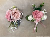 Front view of both wrist corsage and boutonniere showing flower arrangement, pearls and ribbon
