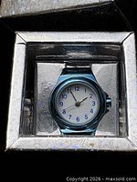 Ring watch in presentation box showing blue case and dial