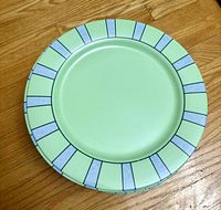 Stack of light green plates with segmented blue/green border