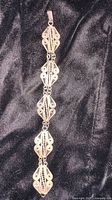Full view of bracelet showing six filigree panels