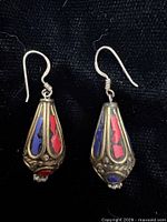 front view of earrings showing inlay colors and shape