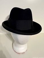 Front side view of black Stetson fur felt fedora on display head