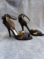 Side view of both shoes showing glitter finish, peep toe, ankle straps, heel height