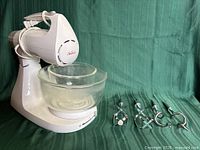 Mixer body with large bowl and four attachments displayed