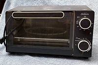 Front view of Sunbeam toaster oven showing controls, door, power cord