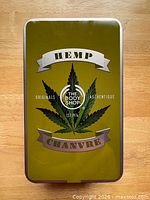 Front of metal tin with hemp leaf and branding