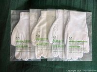 Front view of four sealed glove packages