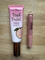 Foundation and lip gloss side by side