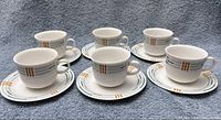 Six demitasse cup and saucer pairs displayed front