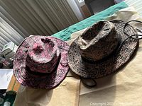Both snake-print hats side by side showing colors and pattern