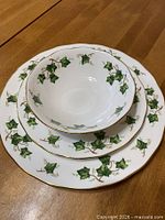 Stacked dinner plate, salad plate and soup bowl showing Ivy Leaf pattern and gold trim