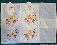 Four placemats and four folded napkins showing full embroidery detail