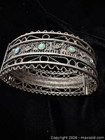Bracelet closed showing filigree and turquoise cabochons