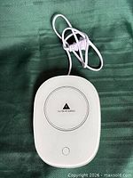 Top view of white mug warmer with attached cord