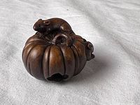 Top view of carved wood pumpkin with mouse on top and opening visible