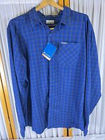 Front view of Columbia blue plaid shirt on hanger with tag visible