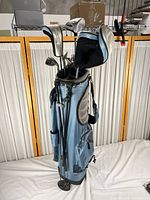 Full view of blue stand bag loaded with clubs