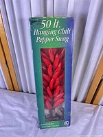 Front of retail box showing 50-light hanging chili pepper swag