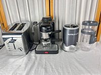 Group shot of toaster, espresso machine, NutriBullet base and cup