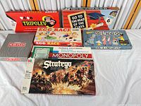 All seven boxed games laid out