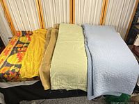 All five textiles laid out side by side