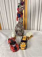 Full group: fabric llama, two wool sheep, two toy cars