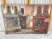 Full view of stretched canvas print showing entire European street café scene