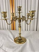 Front view of polished brass 5-light candelabra