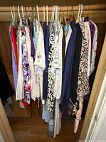 Wide view of closet rod with all garments hanging
