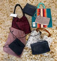 Group shot of all seven handbags on carpet