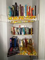 Overview of three shelves filled with assorted books