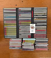 Overview of full lot showing CD binder racks and additional stacked jewel cases