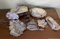 Overall lot view showing all sterling and silver-plated items together on table