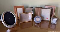 Overview of nine assorted picture frames on tabletop