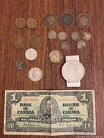 Group shot of assorted coins and 1937 Bank of Canada $1 note