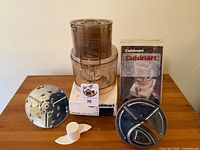 Processor base, bowl with lid, two metal discs, chopping blade, manual visible