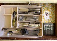 Top view of drawer tray showing Towle flatware, steak knives, boxed crab forks