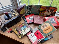 Record player, original box, assorted 45 RPM record sets displayed on window ledge