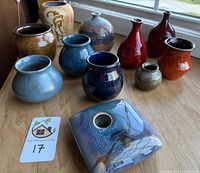 All eleven pottery vases displayed on tabletop