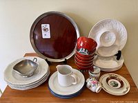 Group shot of entire lot on tabletop showing tray, plates, bowls, cup, pitcher, egg cups