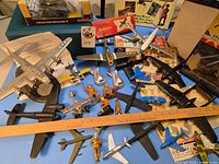 Wide view of aircraft, soldiers, tank, decals, kits, ruler for scale