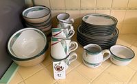 Full lot with stacked plates, mugs, bowls, creamer and sugar bowl