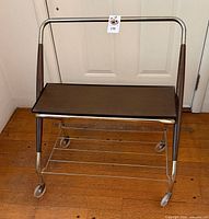 Front view of metal and wood TV cart with wheels