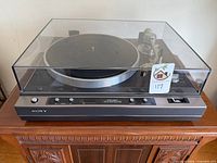 Sony PS-X60 turntable shown with dust cover closed, control panel visible