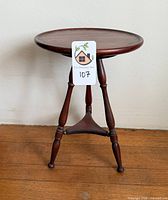 full view of three-legged wooden side table front