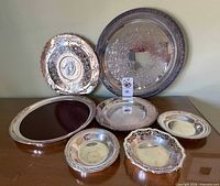 Group view of all seven silver-plated trays and bowls