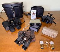 All five binoculars and opera glasses with cases displayed
