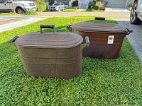 Both wash boilers with lids in outdoor setting