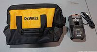 DeWalt tool bag front view with Ryobi charger and cord
